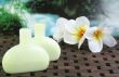 Aromatherapy Oil Bottles With Frangipani Flowers And Rainforest Background. Photo